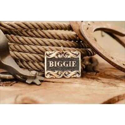 A dog tag with customizable name in a table with western themed decoration